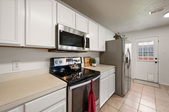 kitchen with visible vents, light countertops, appliances with stainless steel finishes, a textured ceiling, and white cabinetry