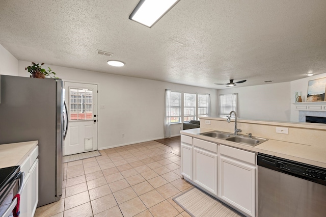 kitchen featuring visible vents, ceiling fan, light countertops, appliances with stainless steel finishes, and a sink