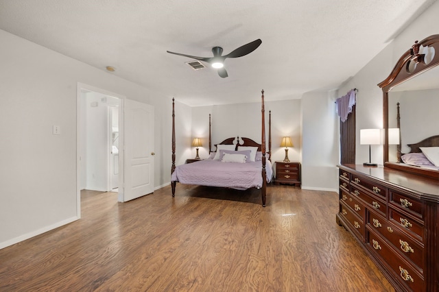 bedroom with visible vents, baseboards, a ceiling fan, and wood finished floors