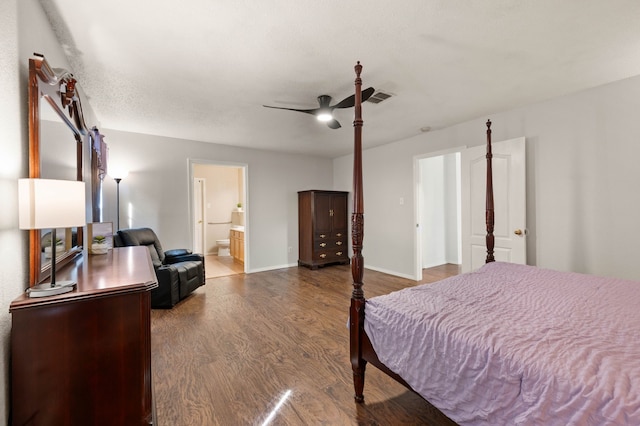 bedroom featuring visible vents, wood finished floors, connected bathroom, baseboards, and ceiling fan