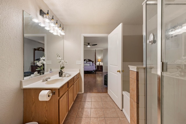 bathroom with tile patterned floors, a textured ceiling, ensuite bath, and a stall shower