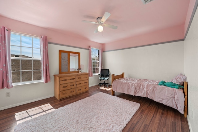 bedroom featuring ceiling fan, baseboards, and wood finished floors