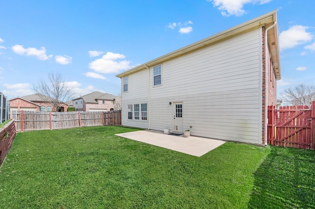 rear view of house featuring a gate, a yard, a fenced backyard, and a patio area