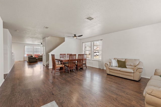 dining area with visible vents, a ceiling fan, a textured ceiling, dark wood-style floors, and baseboards