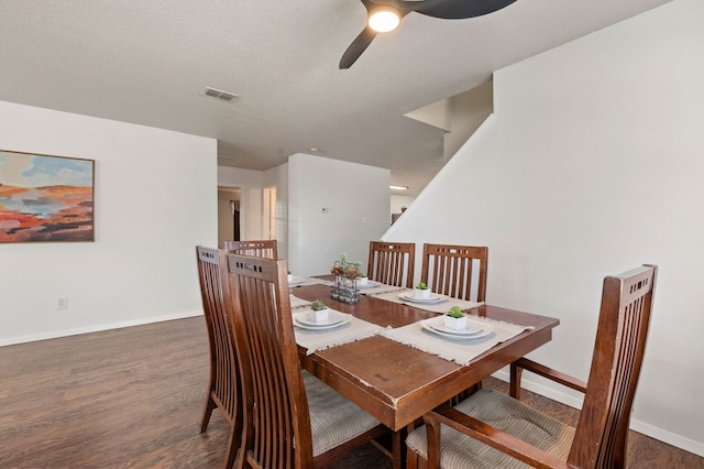 dining space with visible vents, baseboards, wood finished floors, a textured ceiling, and a ceiling fan