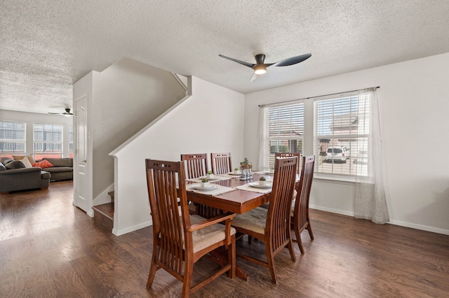 dining room with wood finished floors, stairway, plenty of natural light, and a ceiling fan