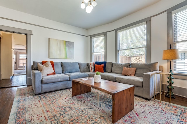 living room featuring a chandelier and wood finished floors