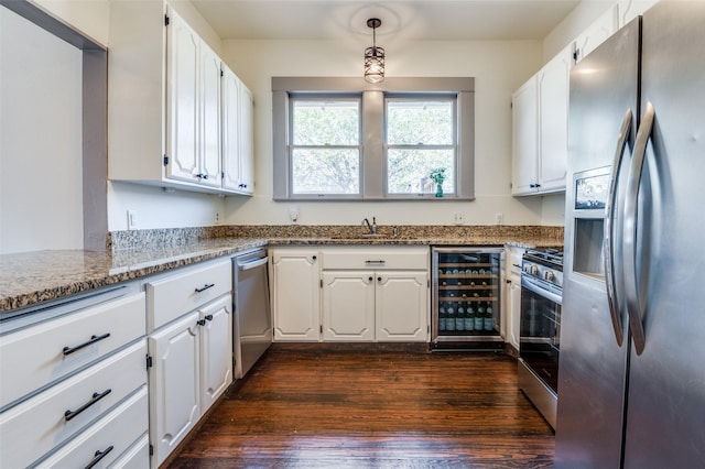 kitchen featuring wine cooler, appliances with stainless steel finishes, dark wood finished floors, and white cabinetry