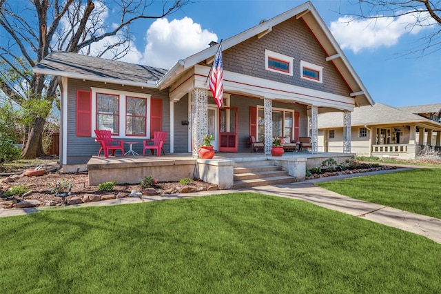 view of front of home with a porch and a front lawn