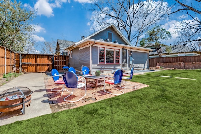 back of house with a patio area, a yard, and fence