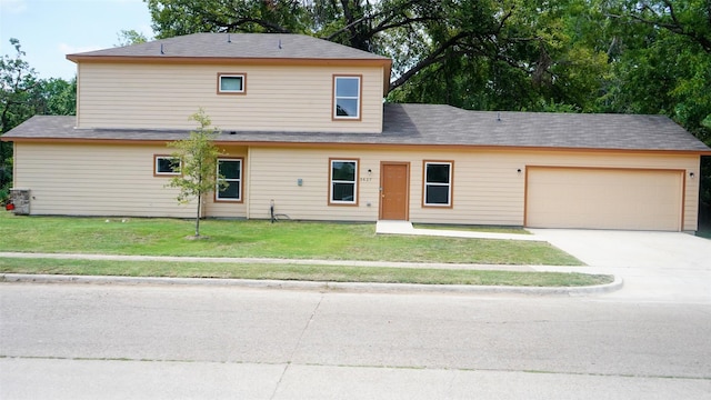 view of front of home with a front lawn, a garage, and driveway