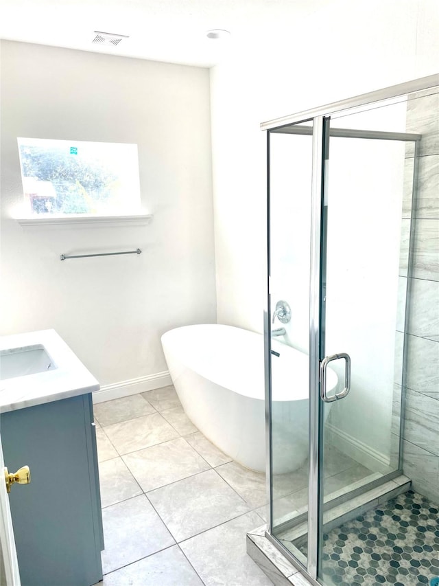 bathroom with vanity, visible vents, a soaking tub, a stall shower, and tile patterned floors