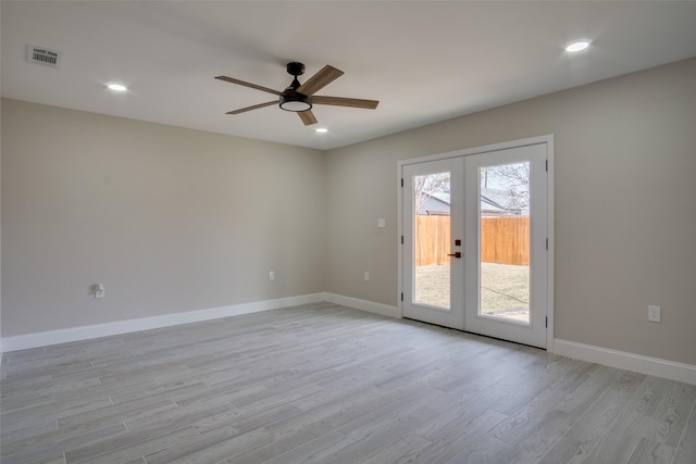 spare room featuring visible vents, ceiling fan, baseboards, french doors, and light wood-style floors