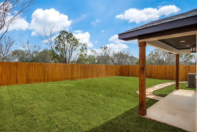 view of yard with central air condition unit, a patio area, and a fenced backyard