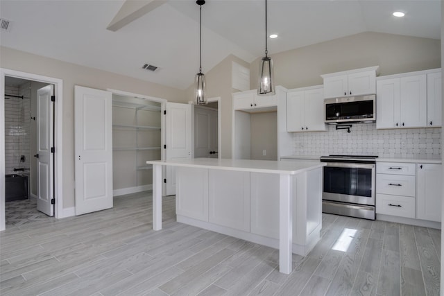 kitchen featuring visible vents, light wood-style flooring, appliances with stainless steel finishes, and light countertops