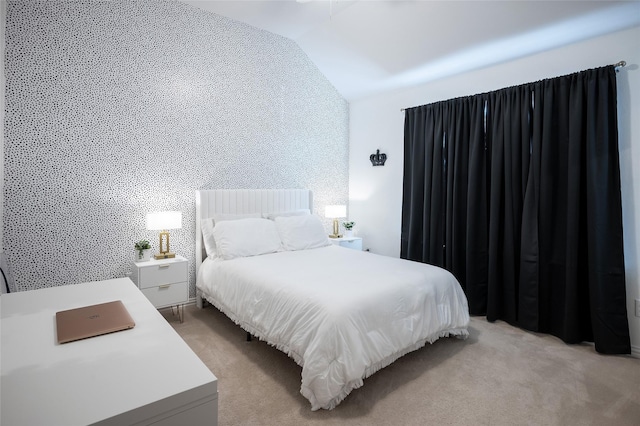 bedroom with light colored carpet and vaulted ceiling