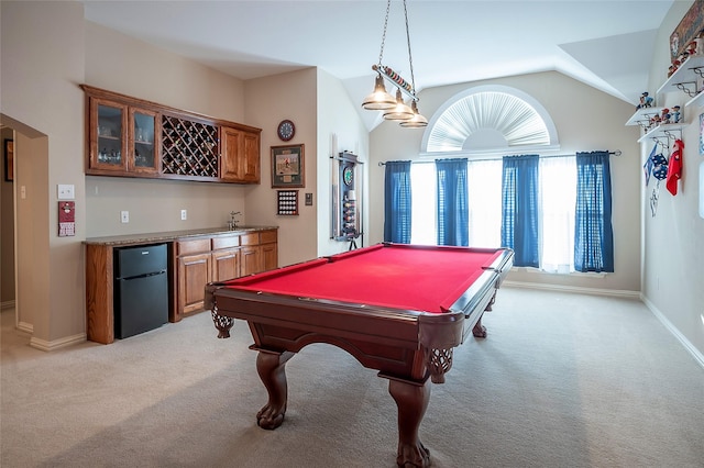 game room with wet bar, lofted ceiling, arched walkways, and light carpet