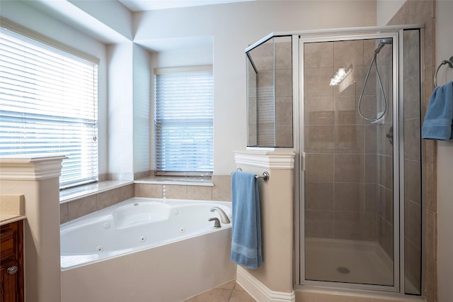 bathroom featuring plenty of natural light, vanity, a whirlpool tub, and a shower stall