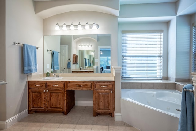 bathroom featuring vanity, tile patterned floors, a jetted tub, and baseboards