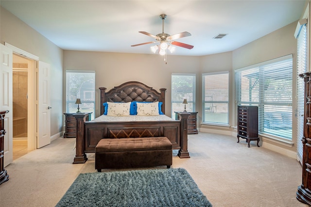 bedroom featuring visible vents, light colored carpet, baseboards, and multiple windows