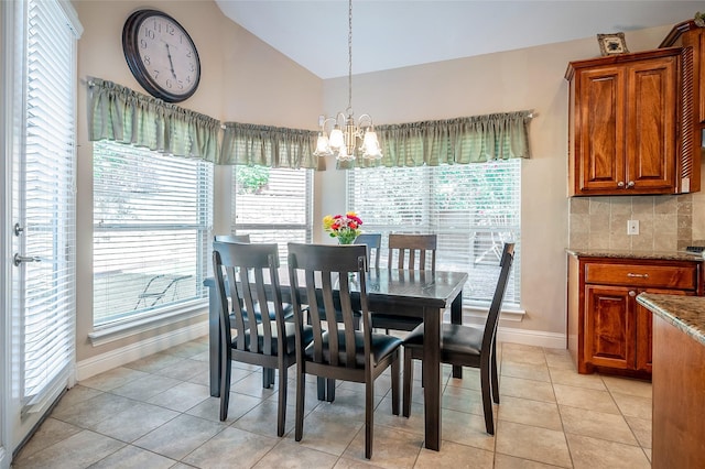 dining area featuring light tile patterned floors, baseboards, lofted ceiling, and a notable chandelier