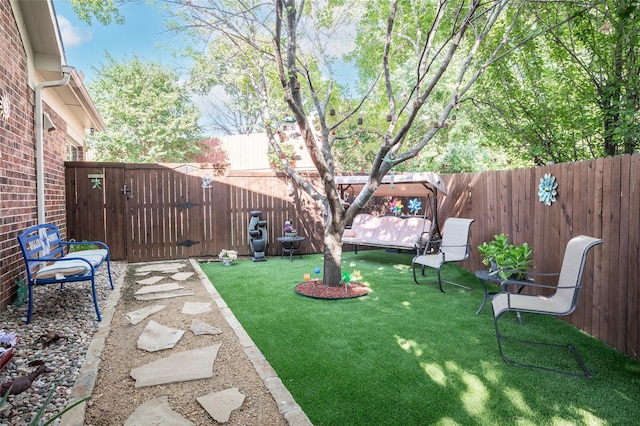 view of yard featuring a gate and a fenced backyard