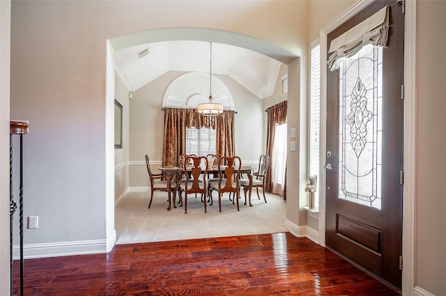 entrance foyer with hardwood / wood-style floors, lofted ceiling, baseboards, and visible vents