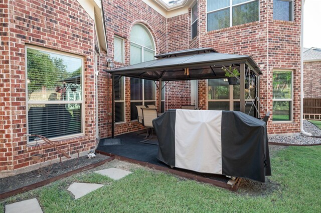 view of patio featuring a gazebo and a grill