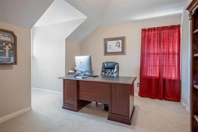 office space with light carpet, baseboards, and lofted ceiling