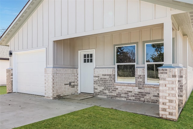 exterior space featuring brick siding, board and batten siding, concrete driveway, and a garage