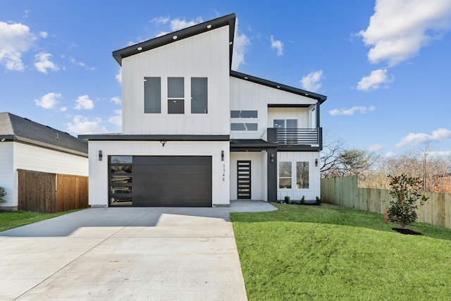 modern home with fence, board and batten siding, concrete driveway, a front yard, and a balcony