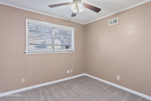 spare room with visible vents, baseboards, carpet flooring, and crown molding