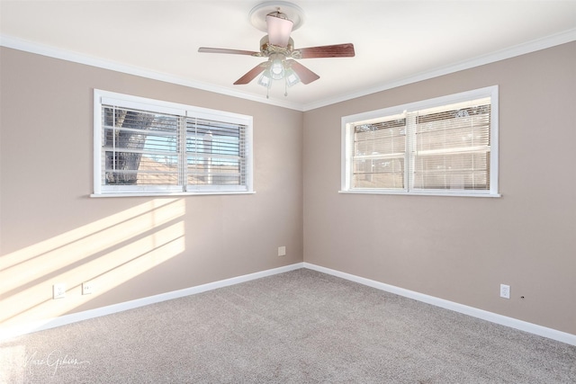 unfurnished room with carpet flooring, crown molding, and baseboards