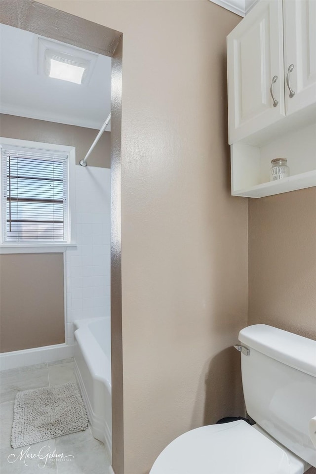 full bathroom featuring tile patterned floors, tub / shower combination, and toilet