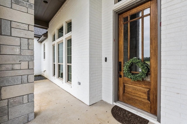 entrance to property with brick siding