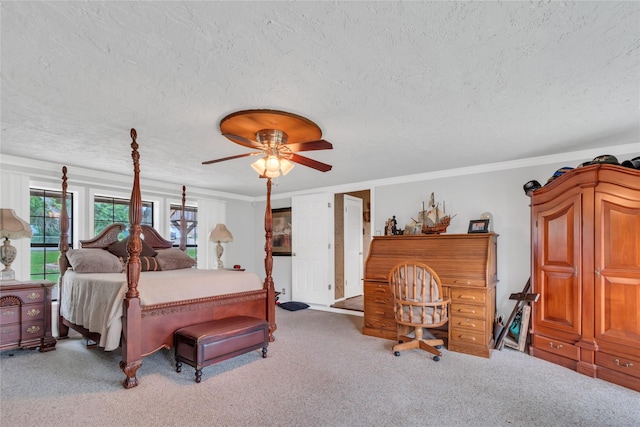 bedroom with a textured ceiling, crown molding, a ceiling fan, and carpet floors