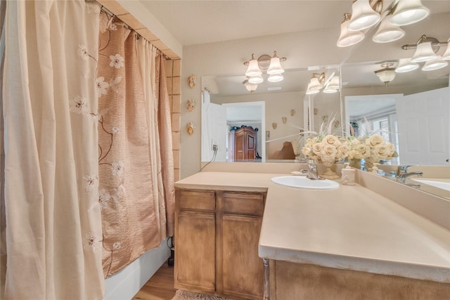 full bathroom featuring wood finished floors, vanity, and shower / bathtub combination with curtain