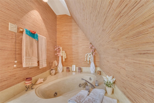 full bath with wooden walls, wooden ceiling, a jetted tub, and vaulted ceiling