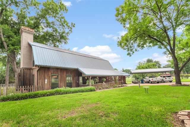 exterior space featuring a carport and a lawn