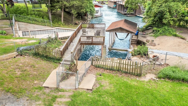 view of jungle gym featuring fence, a yard, and a water view