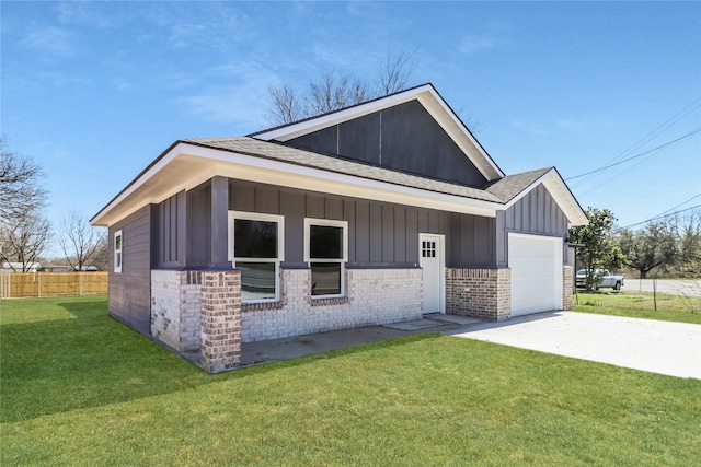 view of front of house with driveway, an attached garage, a front lawn, board and batten siding, and brick siding