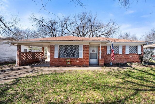 ranch-style house featuring brick siding, an attached carport, driveway, and a front yard