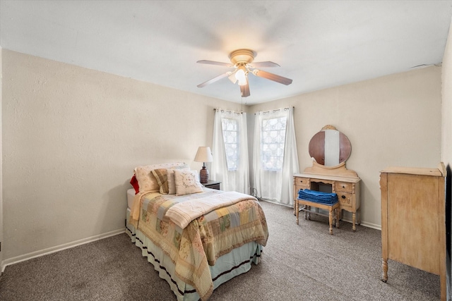 carpeted bedroom featuring baseboards and a ceiling fan