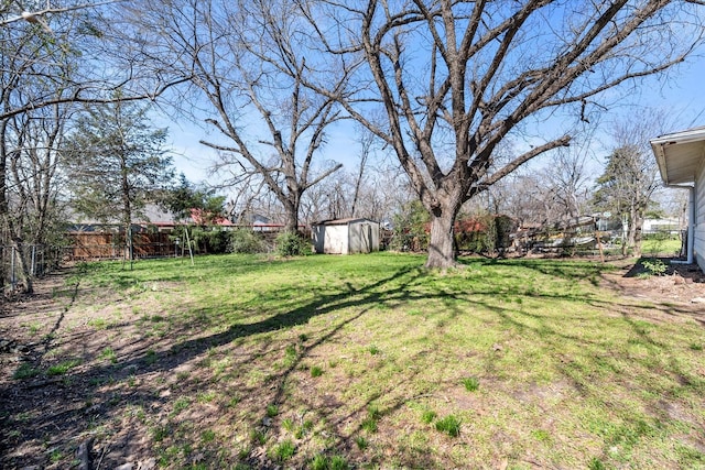 view of yard with a storage shed, a fenced backyard, and an outdoor structure