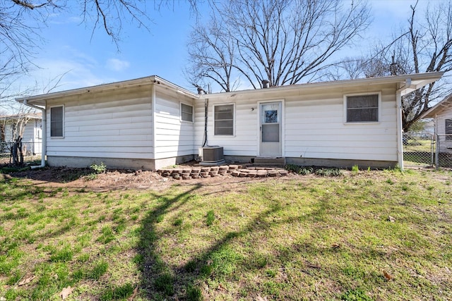 view of front of property with a gate, central AC, a front lawn, and fence