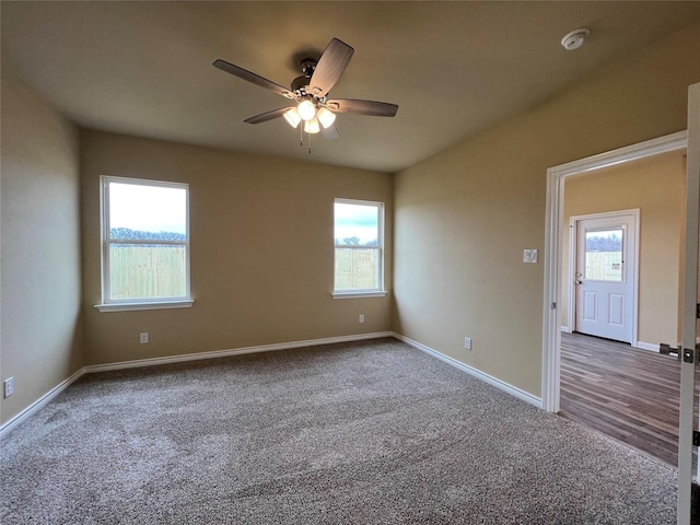 empty room with a ceiling fan, carpet, and baseboards