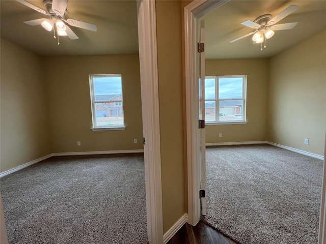 unfurnished room with dark carpet, baseboards, and ceiling fan