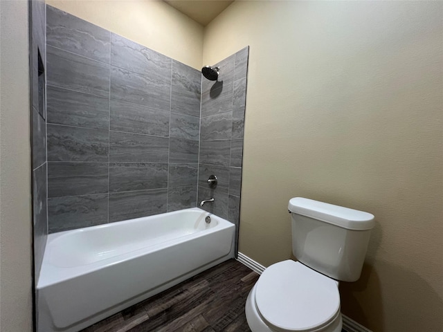 full bathroom with  shower combination, toilet, wood finished floors, and baseboards