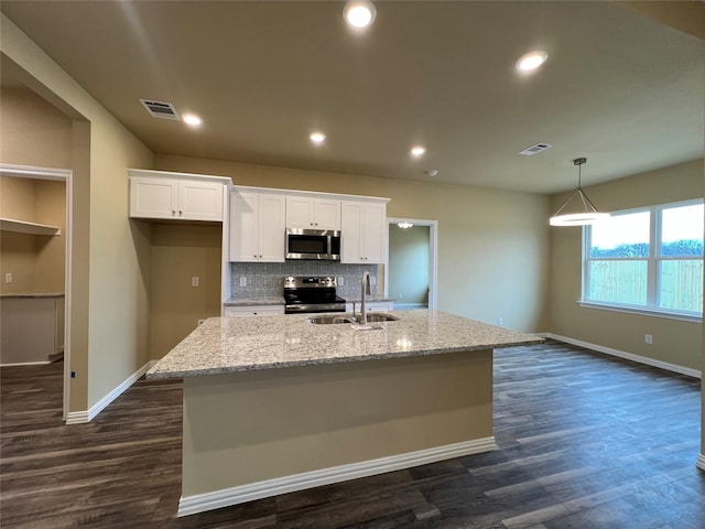 kitchen featuring visible vents, white cabinets, stainless steel appliances, and a sink