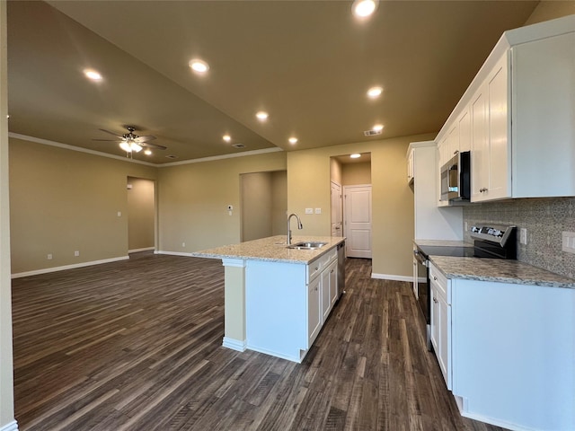 kitchen featuring a sink, decorative backsplash, stainless steel appliances, white cabinetry, and dark wood-style flooring